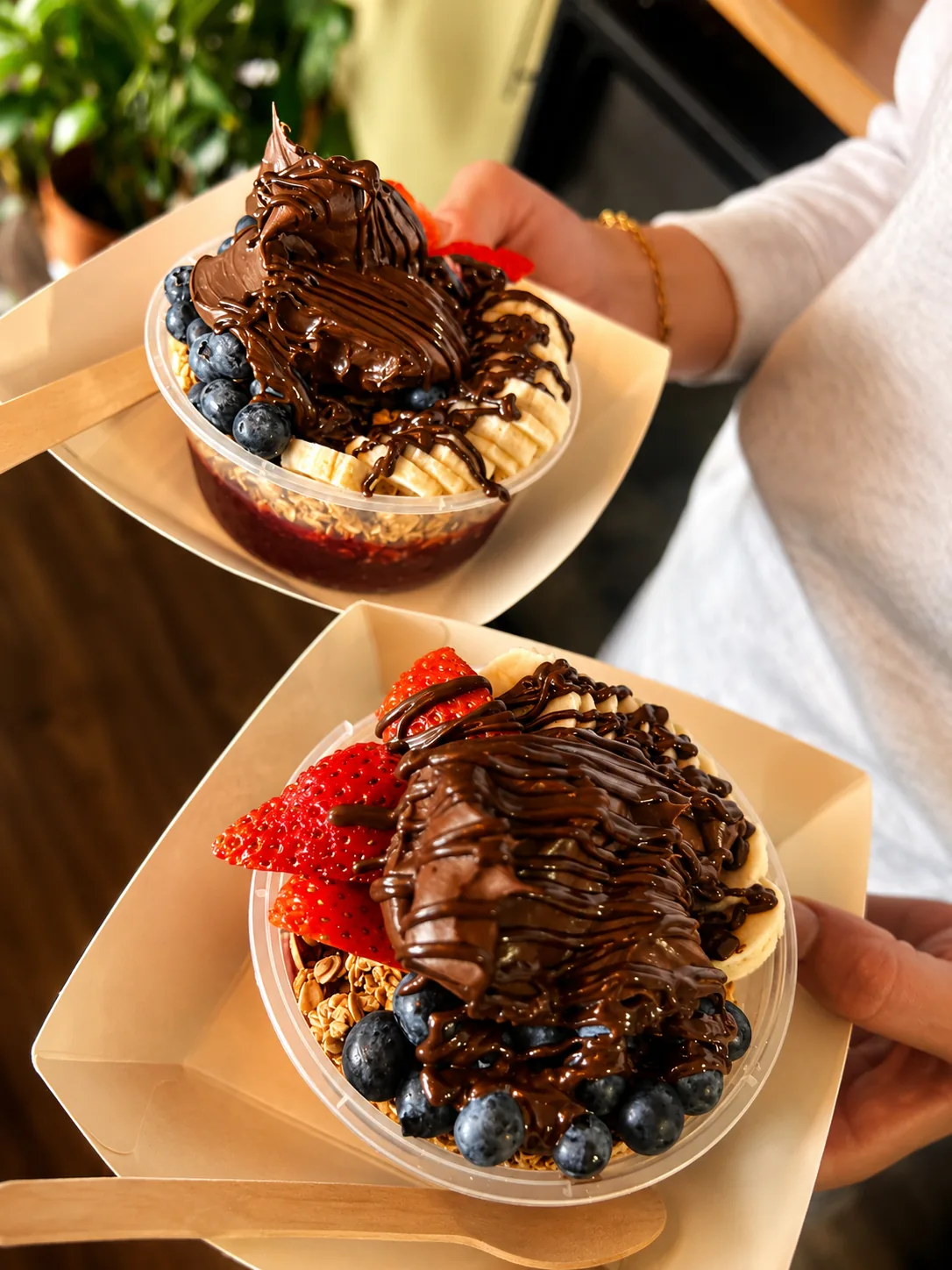 Chocolate-drizzled fruit bowls ready to go at Blend Coffee Shop